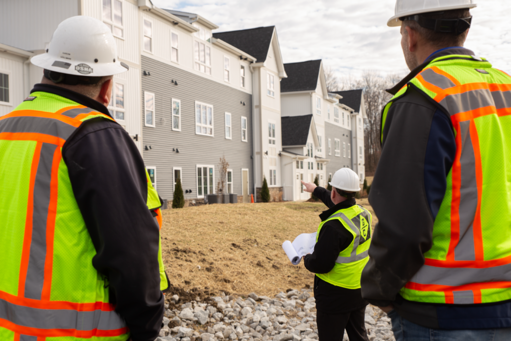 Construction crew looking at building